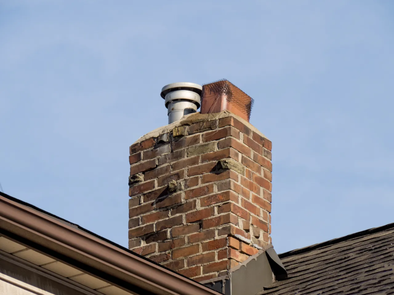 Chimney crown and flashing repair on a roof in New York