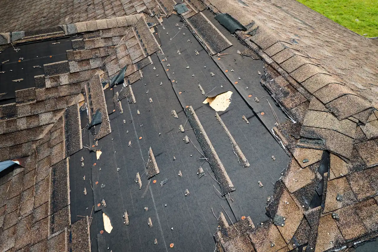 Worn asphalt shingles with heavy granule loss on a New York roof